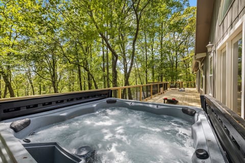 Enjoy the beautiful mountain setting while you take a dip in the hot tub.