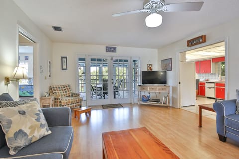 Family room leading out to screened in porch overlooking pool and canal