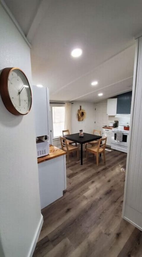 Kitchen with table, stove ,refrigerator, microwave and appliances.