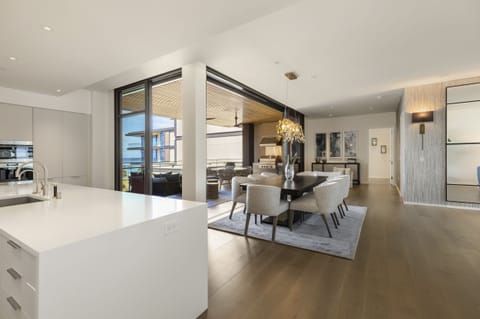 The kitchen overlooks the formal dining area with peek-a-boo ocean views