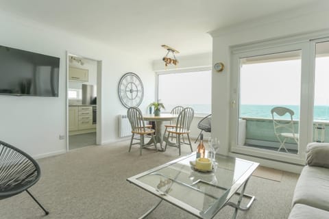 Open plan living/dining and kitchen with sea views