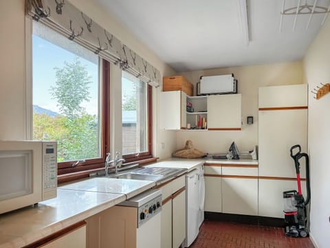 Utility room with washing machine, dryer, freezer and microwave. | Market Stance, Glenelg