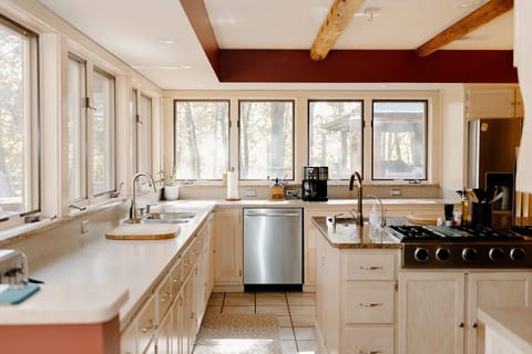 Large kitchen with panoramic views of woods and lake