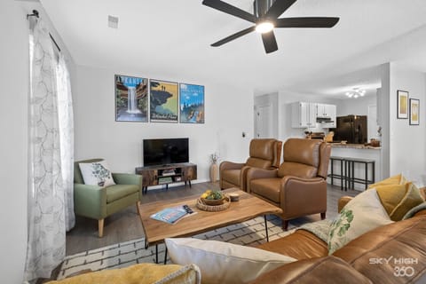 Living room with genuine leather couch and recliners.