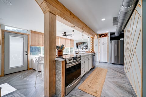 Kitchen is fully equipped with an electric stove with an oven, refrigerator, microwave, and a Keurig