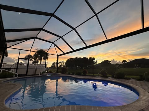 Screened pool with sunset views, ideal for relaxing evenings.
