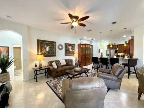 Open-plan living area with comfy seating and direct access to the kitchen.