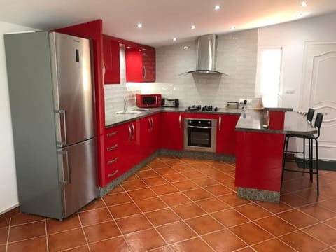 Kitchen area with fridge freezer,washing machine, microwave, oven ,stove.