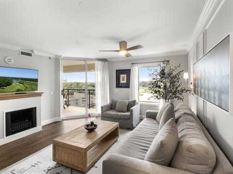 Relax in your bright living room with plush seating, fireplace warmth, and scenic views from your private balcony.