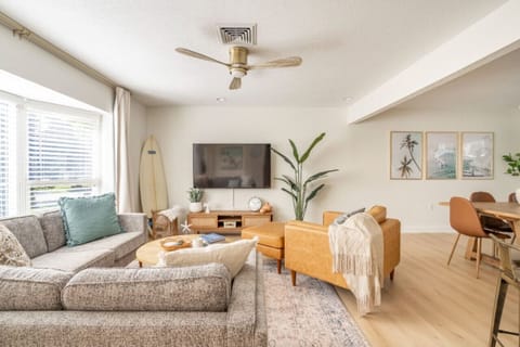 Unwind in the living room, featuring a comfortable couch and a smart TV, perfect for relaxing and enjoying your favorite shows and movies.