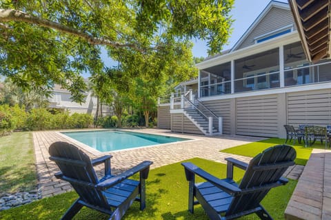 Private backyard oasis featuring a sparkling pool and outdoor grill area—perfect for relaxing or entertaining.