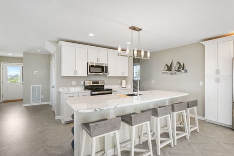 Gleaming Quartz Countertops and Stainless Appliances.