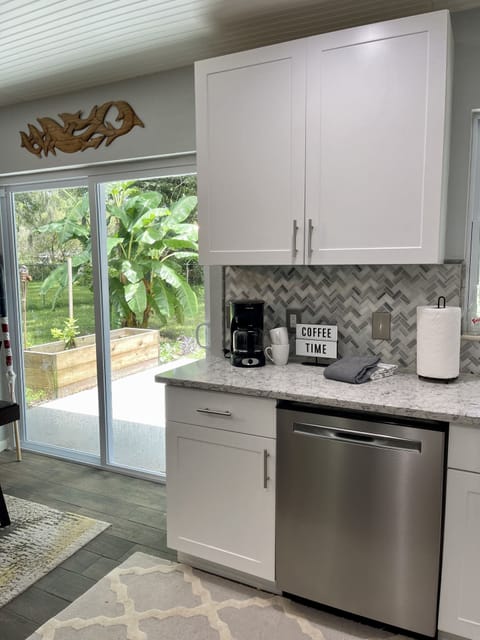 Open & Airy Kitchen/Dining w/Sliding doors leading to fenced private shaded yard