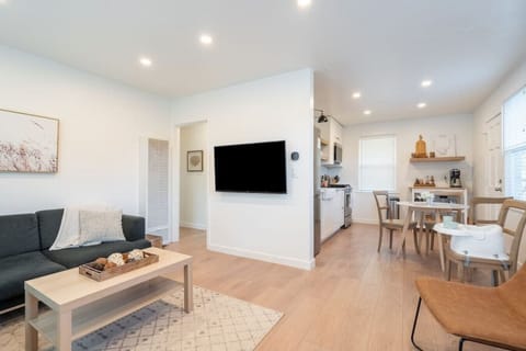 Living Area: Spacious couch, comfortable lounge chairs, 50 inch smart TV, and games.