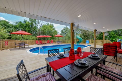 The Backyard - There is plenty to do at Bama Cottage! Out in the back there is a pool (no slide - relocated to playground). There's also sun lounging chairs and a covered area for dining and grilling out.