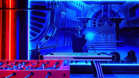 Epic Star Wars-themed game room with glowing neon lights, foosball, and air hockey!