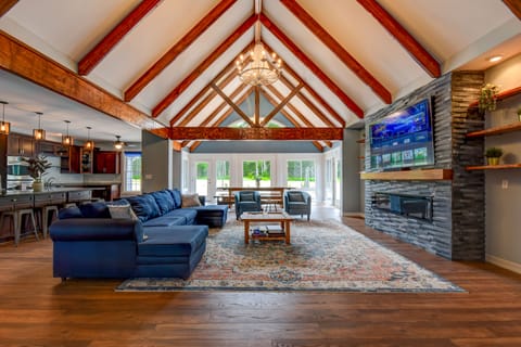 Large living room with 85" TV and sound system.