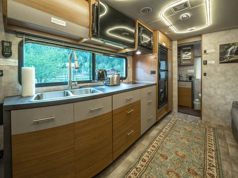 The kitchen has ample space to prepare meals. There is also a 32” TV. 