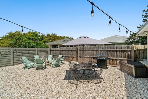 Expansive outdoor living space with custom fire pit, patio set w/umbrella, grill