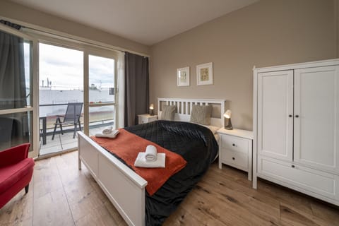 Bedroom 3 with balcony, double bed, wardrobe and work desk 