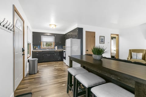 Equipped with a sleek bar counter and three cozy bar chairs!