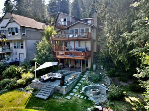 The waterfront home has endless outdoor space, water toys, and a hot tub.