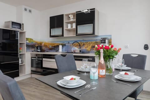 A dining area adjacent to the kitchen, with a table set for a delightful meal.

