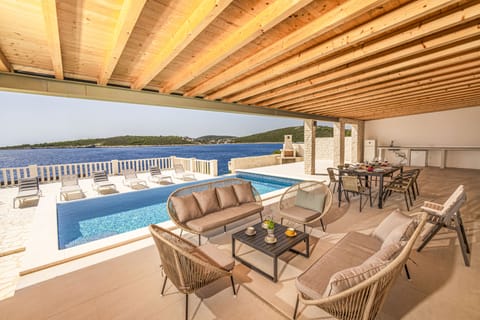 Dining terrace with summer kitchen and BBQ overlooking the pool