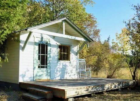 The Angler cabin sits riverside, has a private deck and table, two chairs