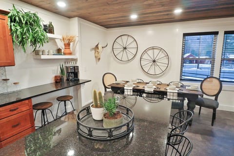 Open fully equipped kitchen, dining area, and living room.