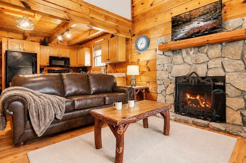 Living room with queen pull out bed, fireplace and smart TV.
