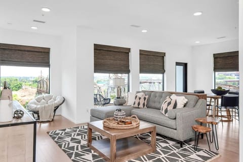 Bright and spacious living room that opens to the kitchen. The couch turns into a sleeper sofa. Custom blackout blinds. Smart TV equipped with YouTube TV for cable.