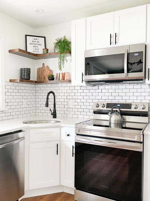 The fully stocked kitchen offers stainless steel appliances.