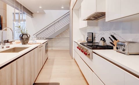 Kitchen: Chef’s dream with Wolf + Sub-Zero appliances and open layout.