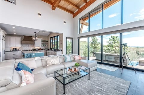 - Soak in breathtaking mountain views through soaring floor to ceiling windows
- Cloud soft sectional and cozy textiles create the perfect gathering space
- Open design blends nature, comfort, and style in one seamless setting