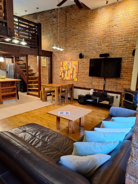 Living room, dining area, and stairs to mezzanine level 