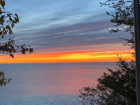 EXTERIOR:  A beautiful sunset on Lake Michigan looking from the cottage.
