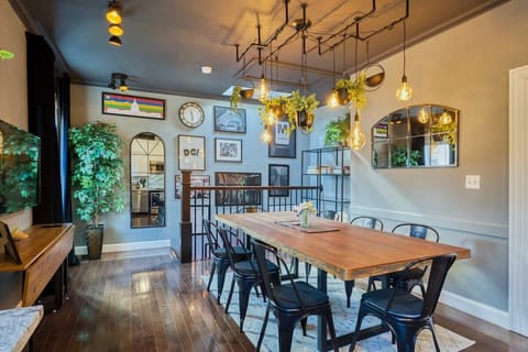 On the Metro movie house's 2nd floor, find a cozy dining area for 8 with board games, a 42" TV with streaming, next to the kitchen. Features a dimmable light fixture I designed for perfect ambiance.