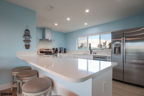 White granite countertops, new appliances, and cabinetry make this spacious Kitchen a pleasure to entertain