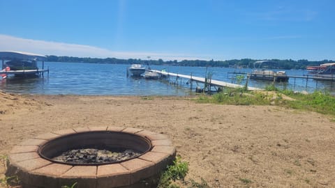 50 feet of sandy lake front and a stone fire pit.