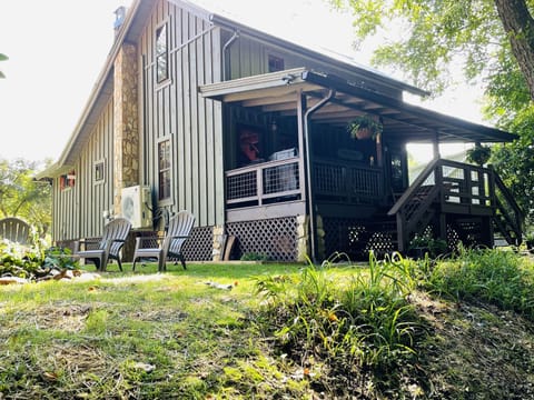 Side view of the cabin and  fire pit from the riverbank