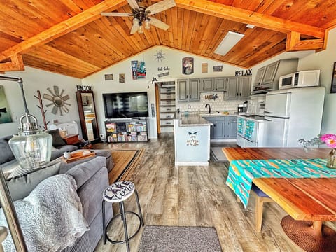 Living, dining and kitchen. That is a 70 inch smart tv. :)