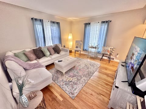 Living room with 58” RUKU tv, couch, chairs, and games!