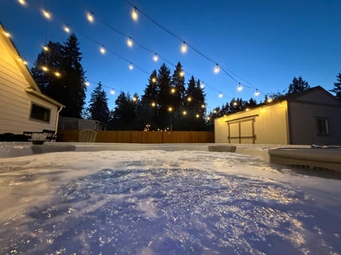 Private backyard with a hot tub and ambient lighting to make your evening more enjoyable.