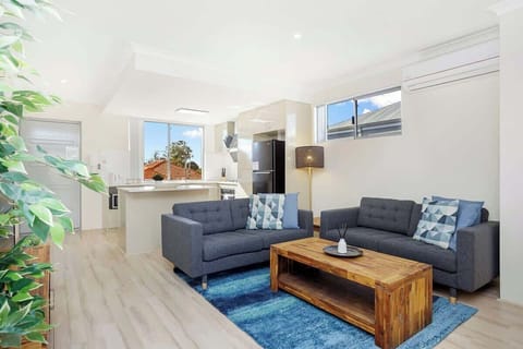  Relax on the comfortable sofas, enjoy easy access to the fully equipped kitchen, and unwind in an inviting atmosphere perfect for your stay.