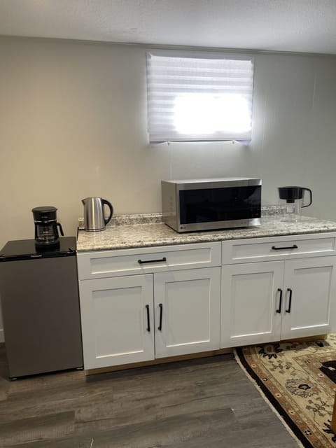 Microwave, coffee maker, tea kettle for hot water and Brita water filter.