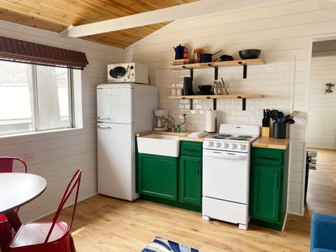 The kitchen now has new tile backsplash, new cabinets, new butcher block countertops, and all new appliances.