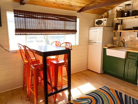 The dining table is a countertop height table that seats 4.