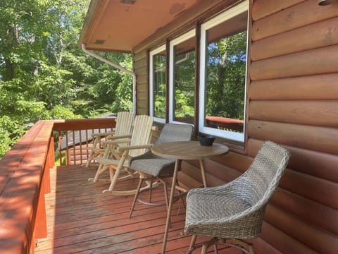 Front deck overlooking golf course has seating for four and a bistro table