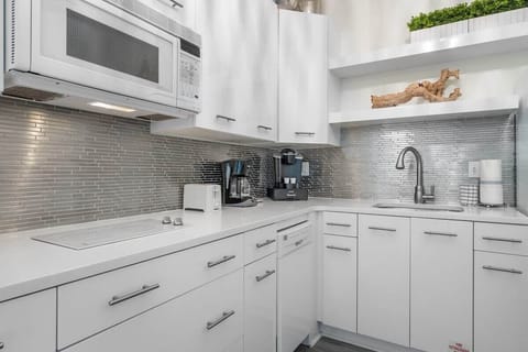 The kitchenette is equipped with granite countertops, a coffee maker, microwave and refrigerator.